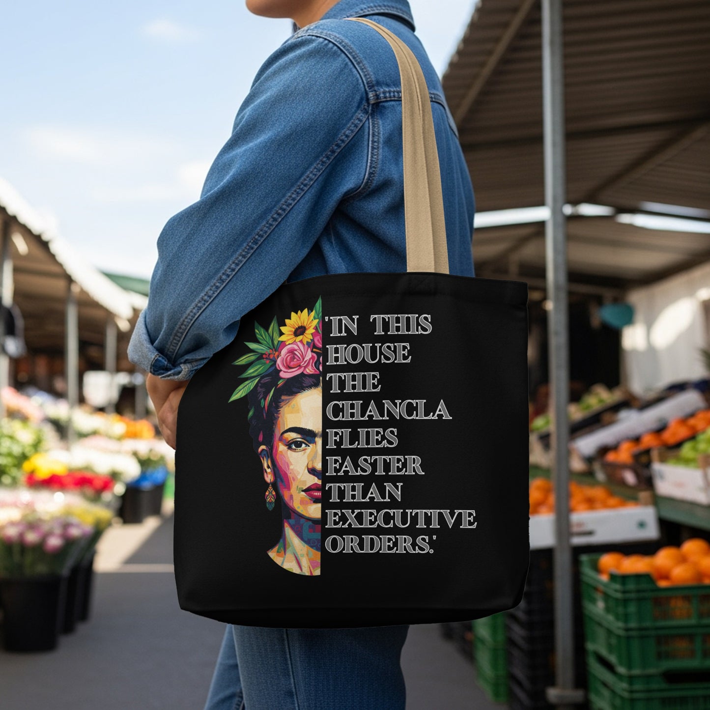 Black tote bag with Frida Kahlo portrait and empowering text.
