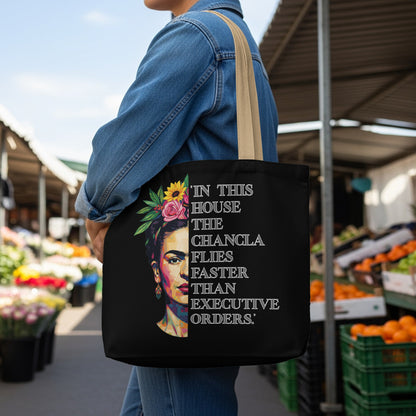 Black tote bag with Frida Kahlo portrait and empowering text.
