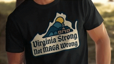 a black t-shirt with a graphic design on it, which includes a mountain and a house. The text on the t-shirt reads "Virginia Strong Not MAGA Wrong".