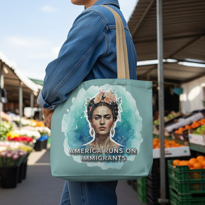 Tote bag with Frida Kahlo portrait and "America Runs on Immigrants" text.