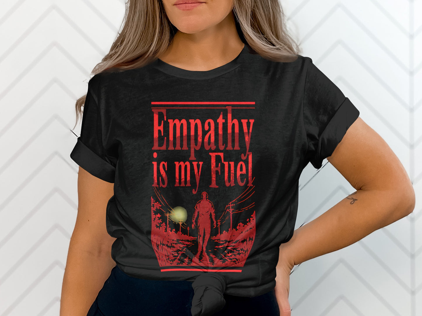 Black t-shirt with red text "Empathy is my Fuel" and a silhouetted figure.