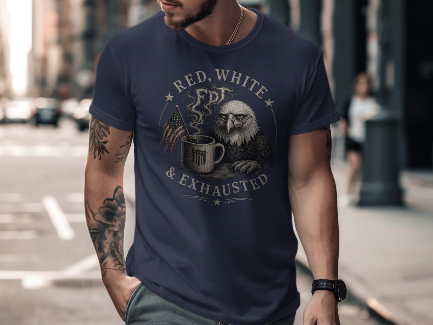 Man wearing navy t-shirt with eagle, coffee mug, and "Red, White & Exhausted" text.