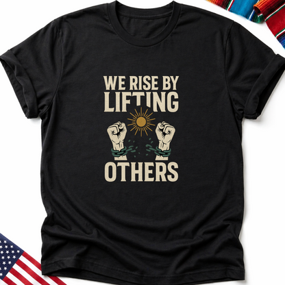 Black t-shirt with "We Rise By Lifting Others" text and clasped hands.