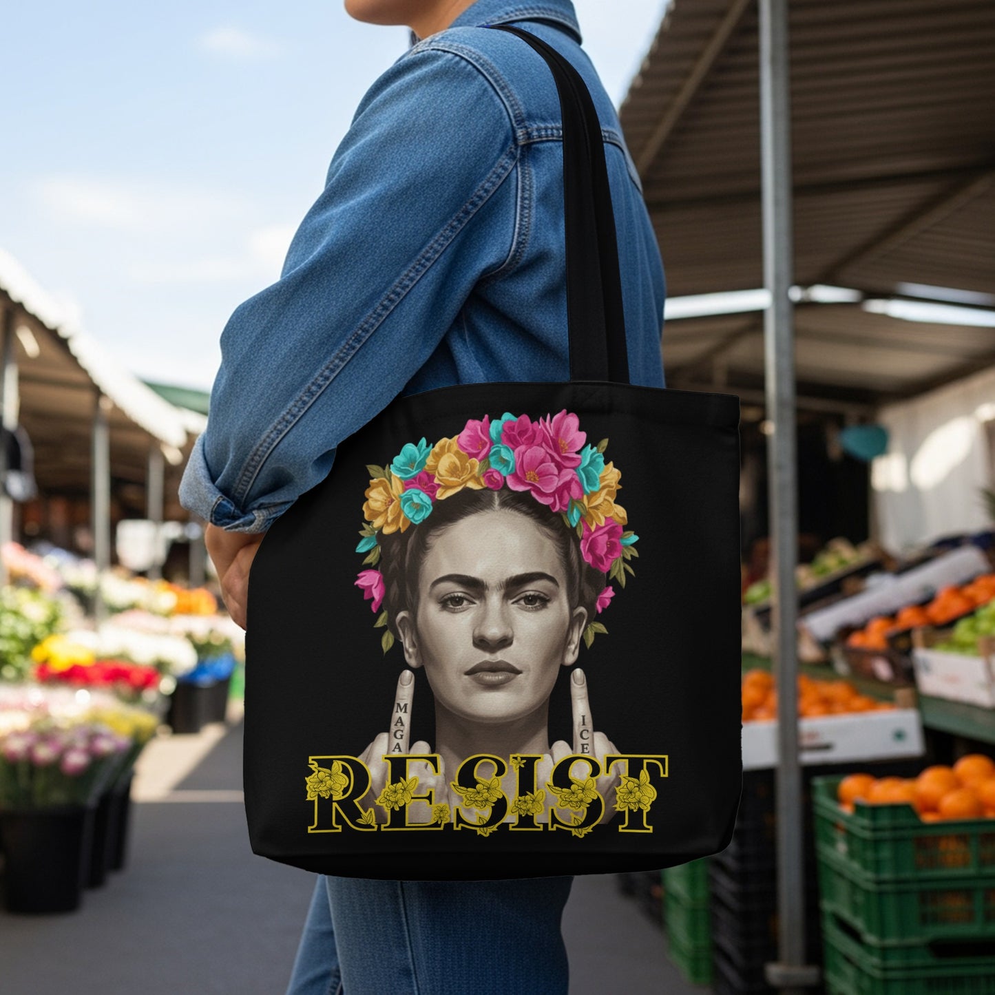 Frida Kahlo with floral headdress and "Resist" text on a black tote bag.