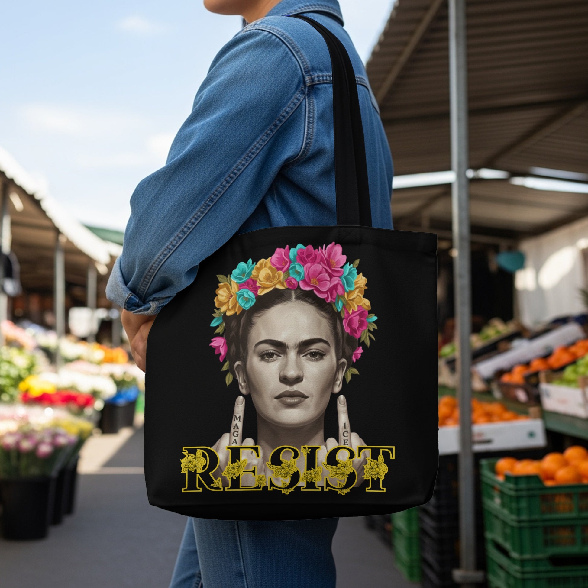 Frida Kahlo with floral headdress and "Resist" text on a black tote bag.