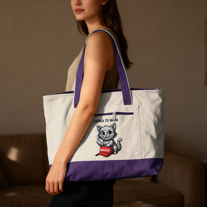 White and purple tote bag with a cartoon cat holding a red hat and text.