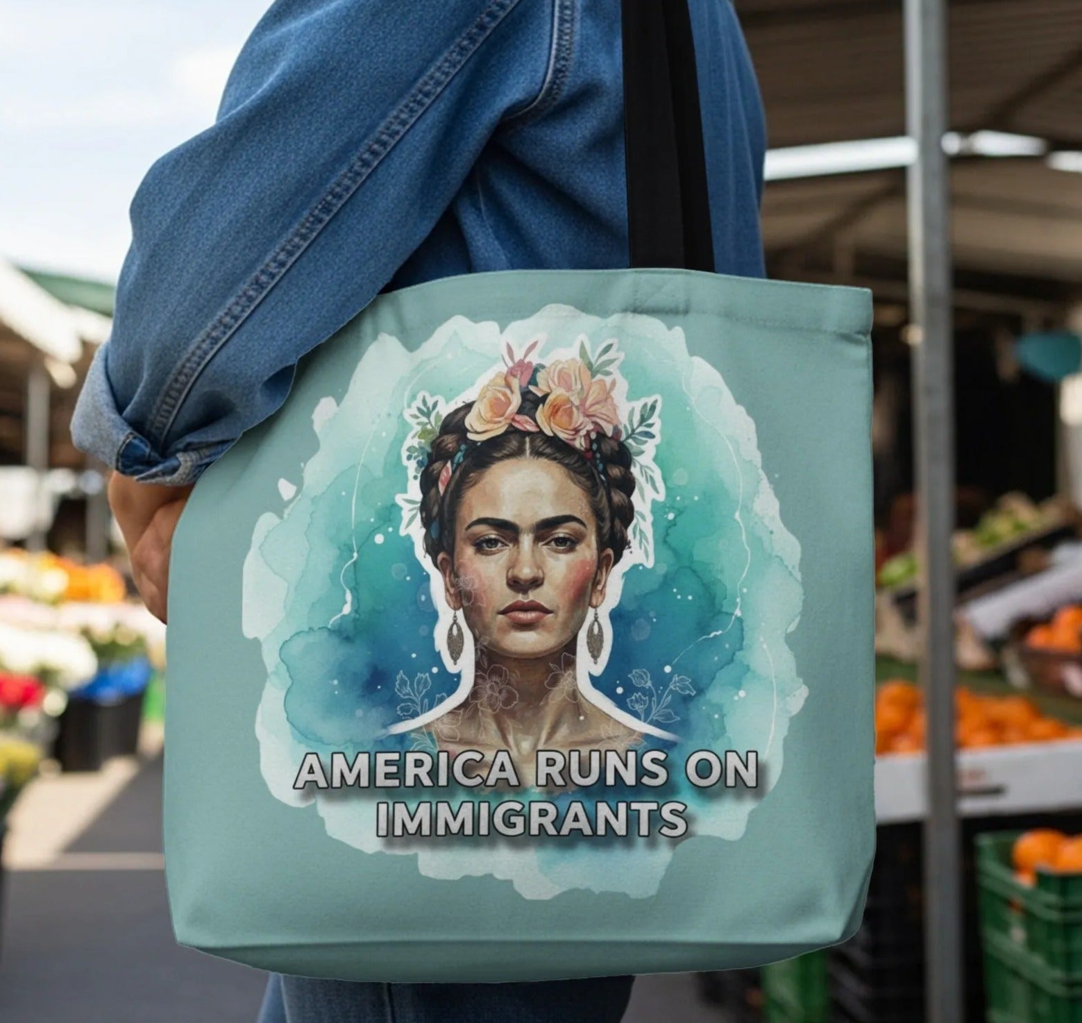 Tote bag featuring Frida Kahlo portrait with "America Runs on Immigrants" text.