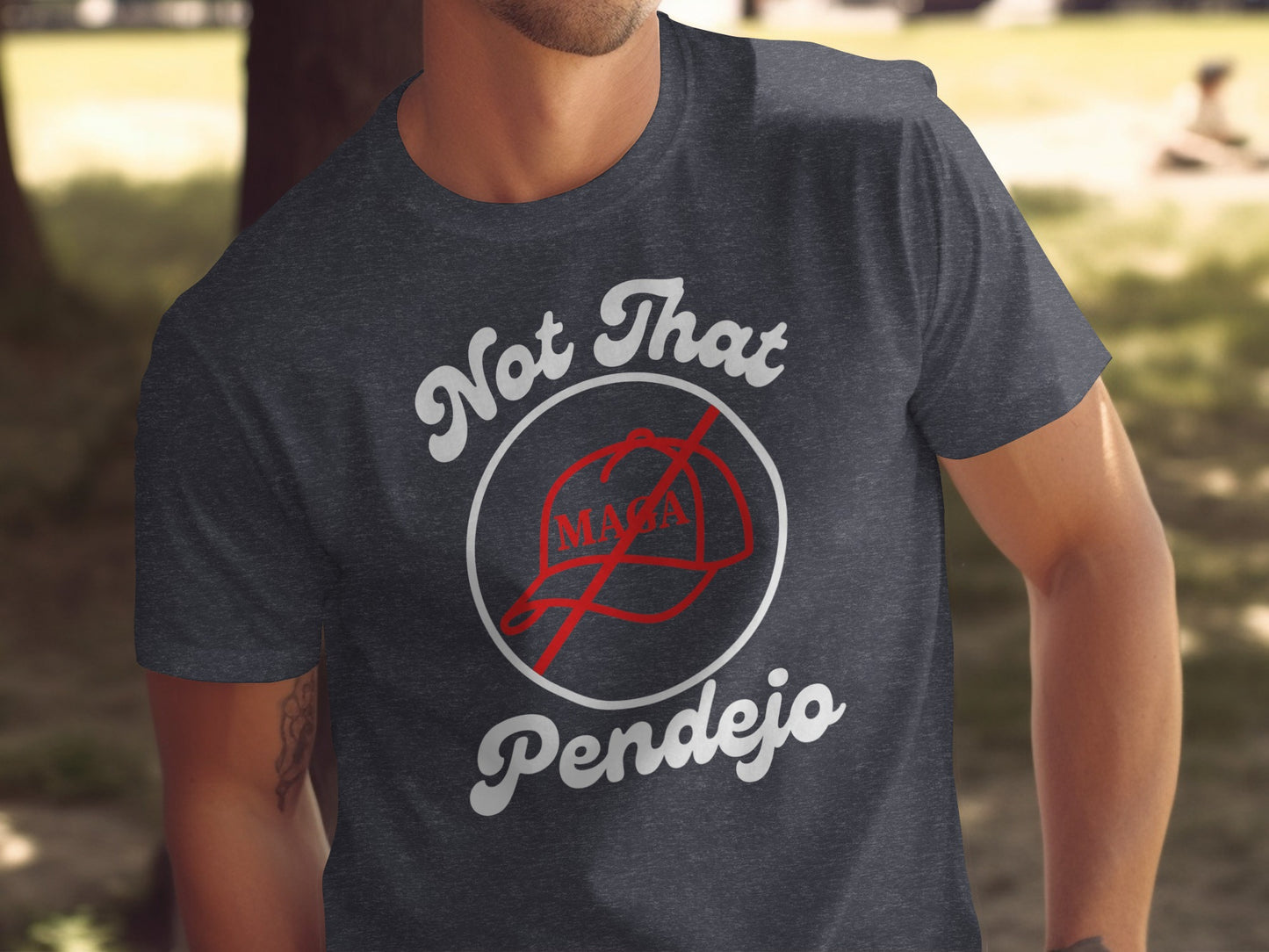 Dark t-shirt with "Not That MAGA Pendejo" text and a crossed-out MAGA hat.