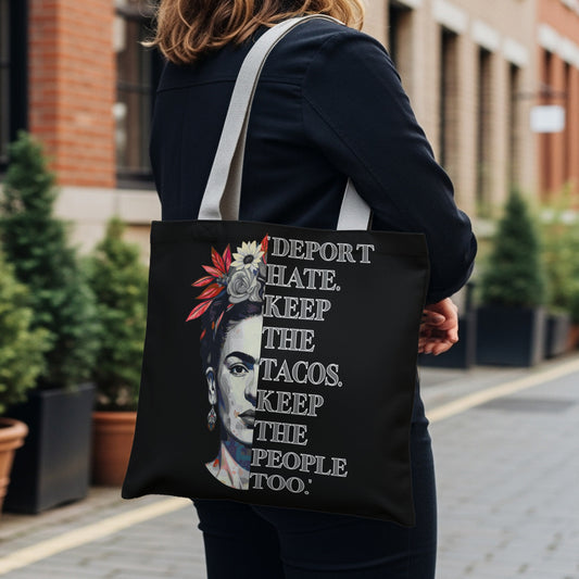 Black tote bag with Frida Kahlo portrait and slogan.