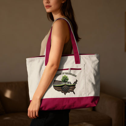Tote bag featuring a USA map with a tree growing from its soil, text "Powered by Immigrants".
