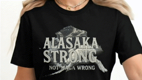 A black t-shirt with the text "ALASAKA STRONG NOT MACHA WRONG" printed on it.