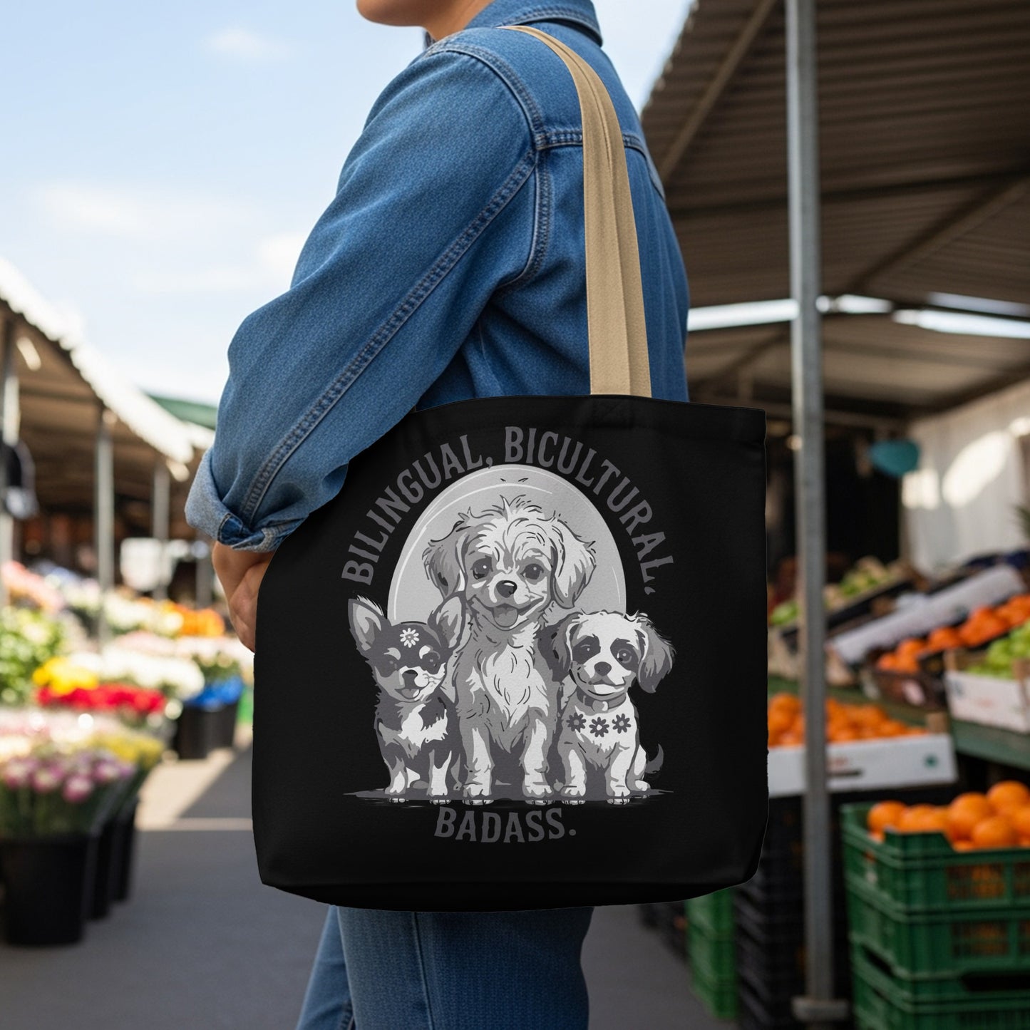 Black tote bag with three dogs and "Bilingual, Bicultural, Badass." text.