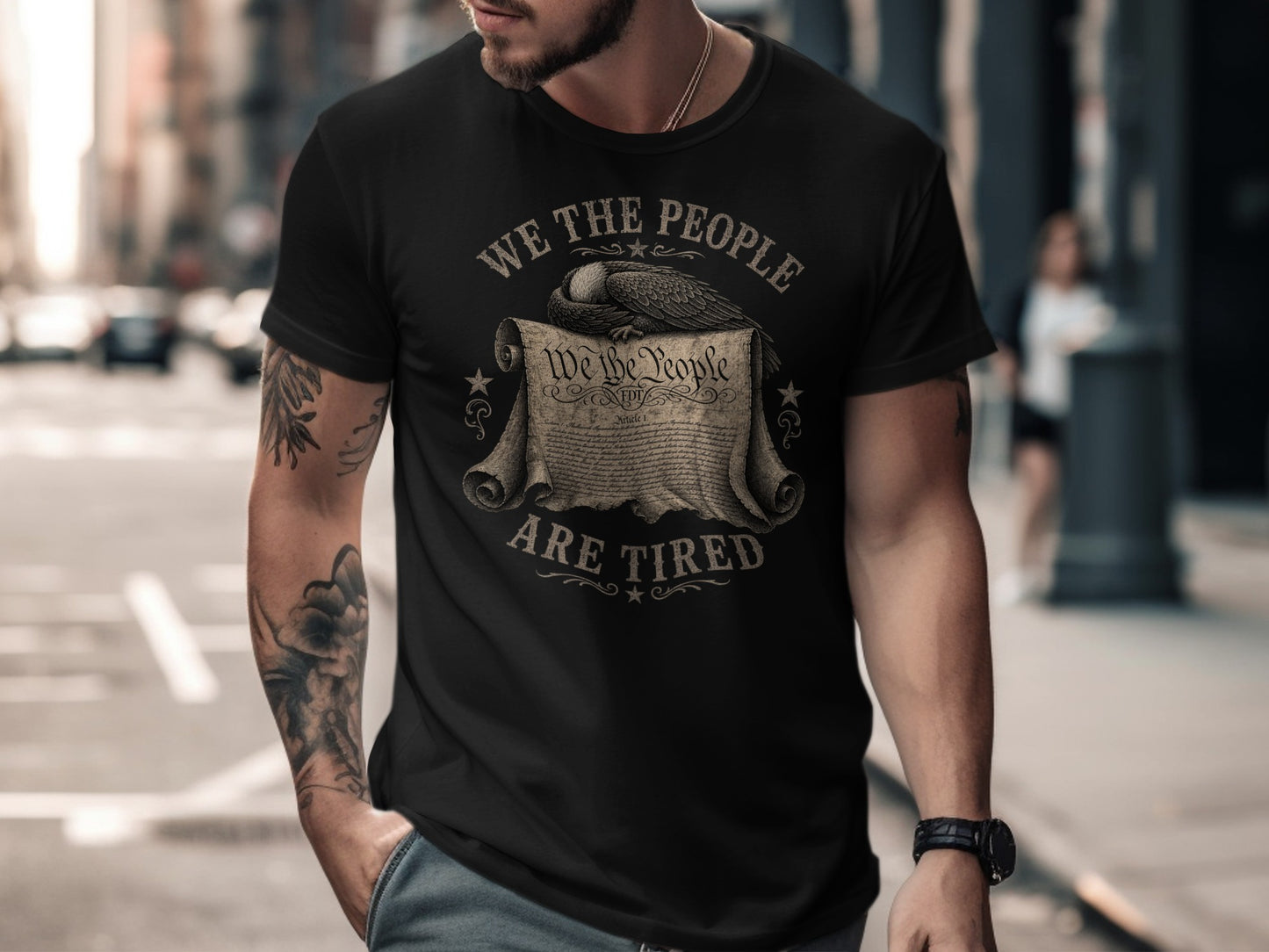 Black t-shirt with "WE THE PEOPLE ARE TIRED" text and eagle over historical document.