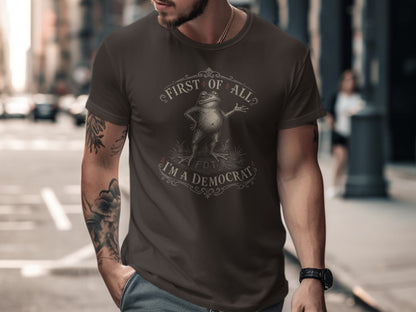 Dark brown t-shirt with "First of all, I'm a Democrat" text and a frog graphic.