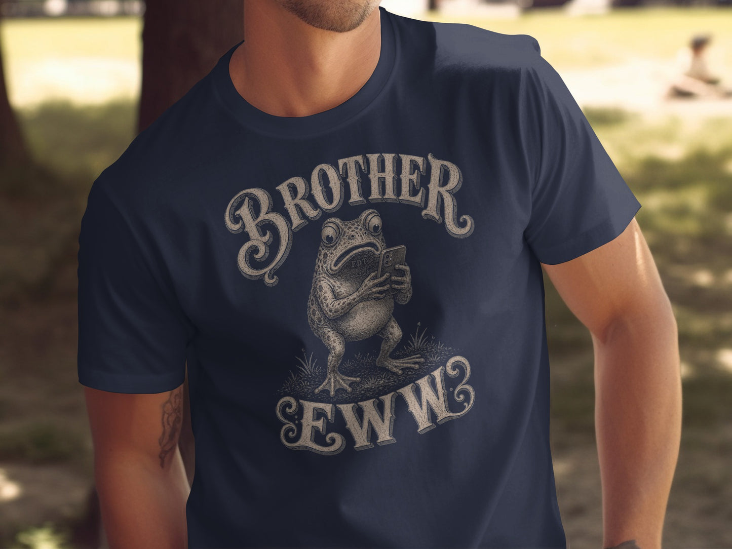 Navy t-shirt with frog saying "BROTHER EWW" while looking at phone.