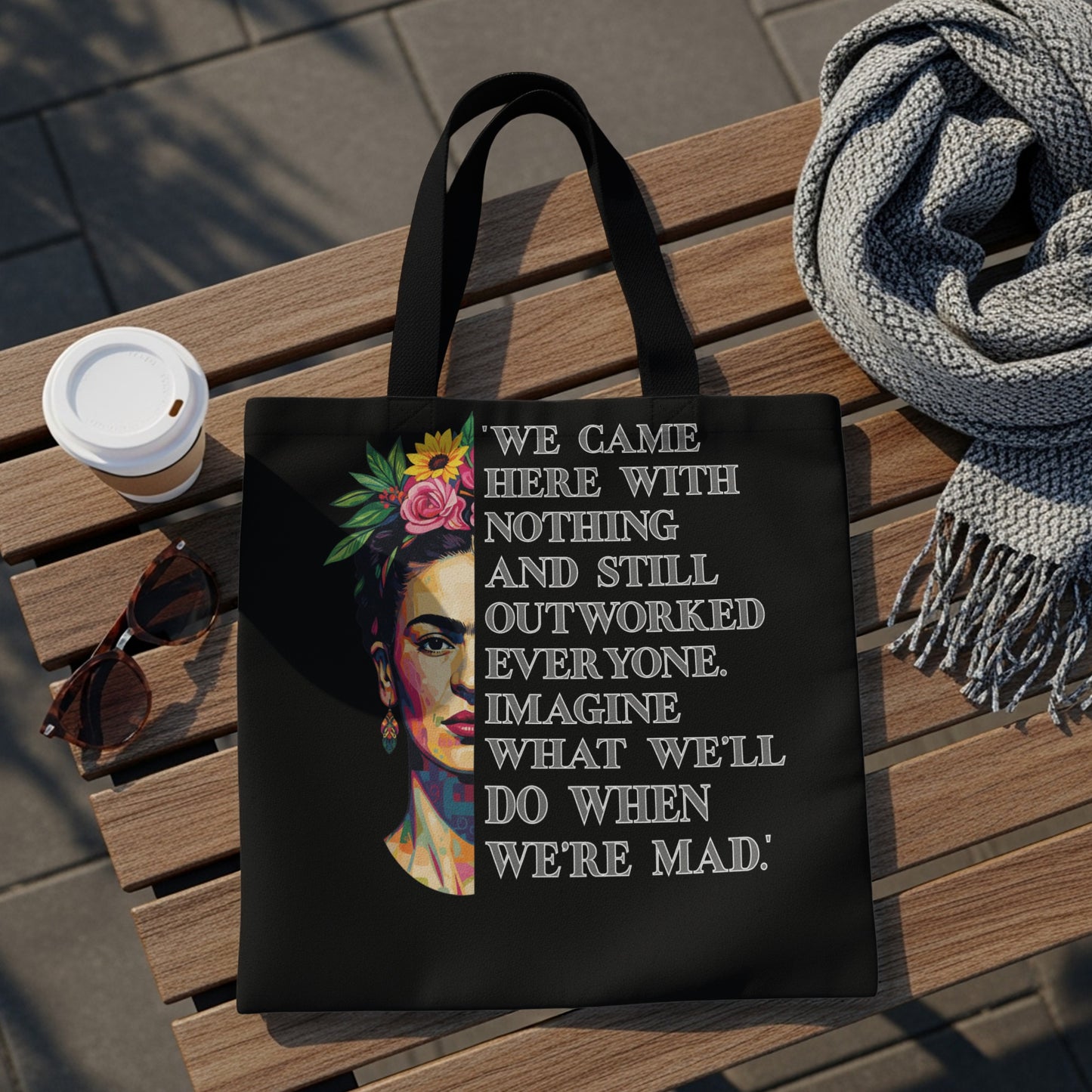 Black tote bag with Frida Kahlo illustration and empowering quote.