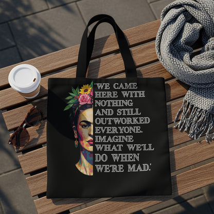 Black tote bag with Frida Kahlo illustration and empowering quote.