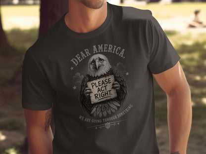 Eagle holding sign "Dear America, Please Act Right" on dark t-shirt.