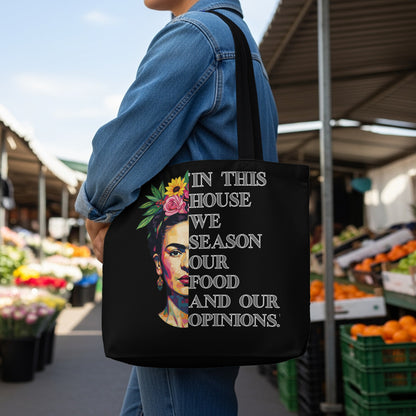 Black tote bag with Frida Kahlo design and text.