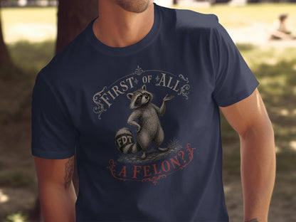 T-shirt graphic with raccoon and text "FIRST OF ALL, A FELON?".
