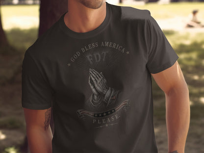 Dark t-shirt with praying hands, "GOD BLESS AMERICA", "FDT", and American flag graphic.